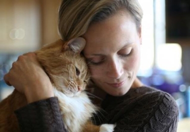 Woman snuggling with a cat